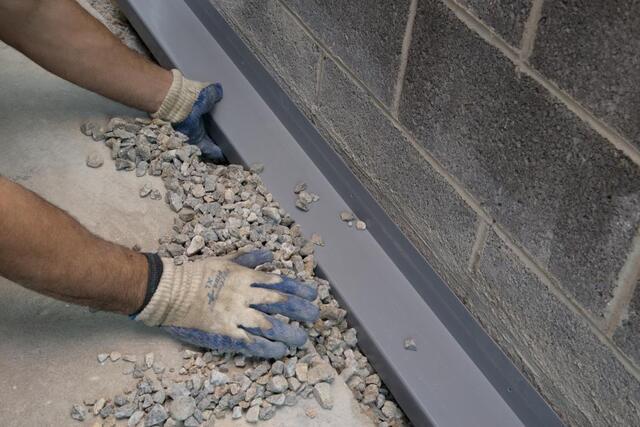 Interior basement waterproofing system installed along a block foundation wall