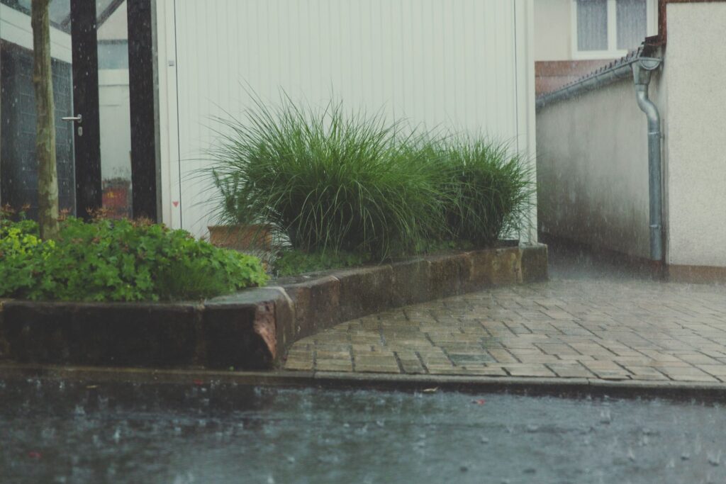 Heavy rain pooling on a residential patio and yard